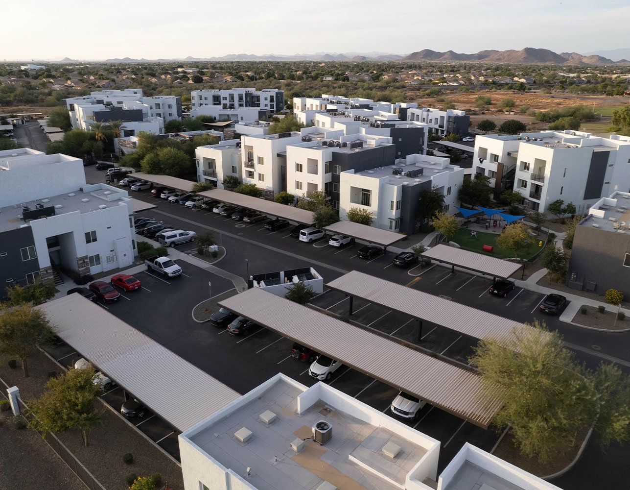 Aerial view of a new apartment complex in Arrowhead, Arizona surrounded by desert landscape